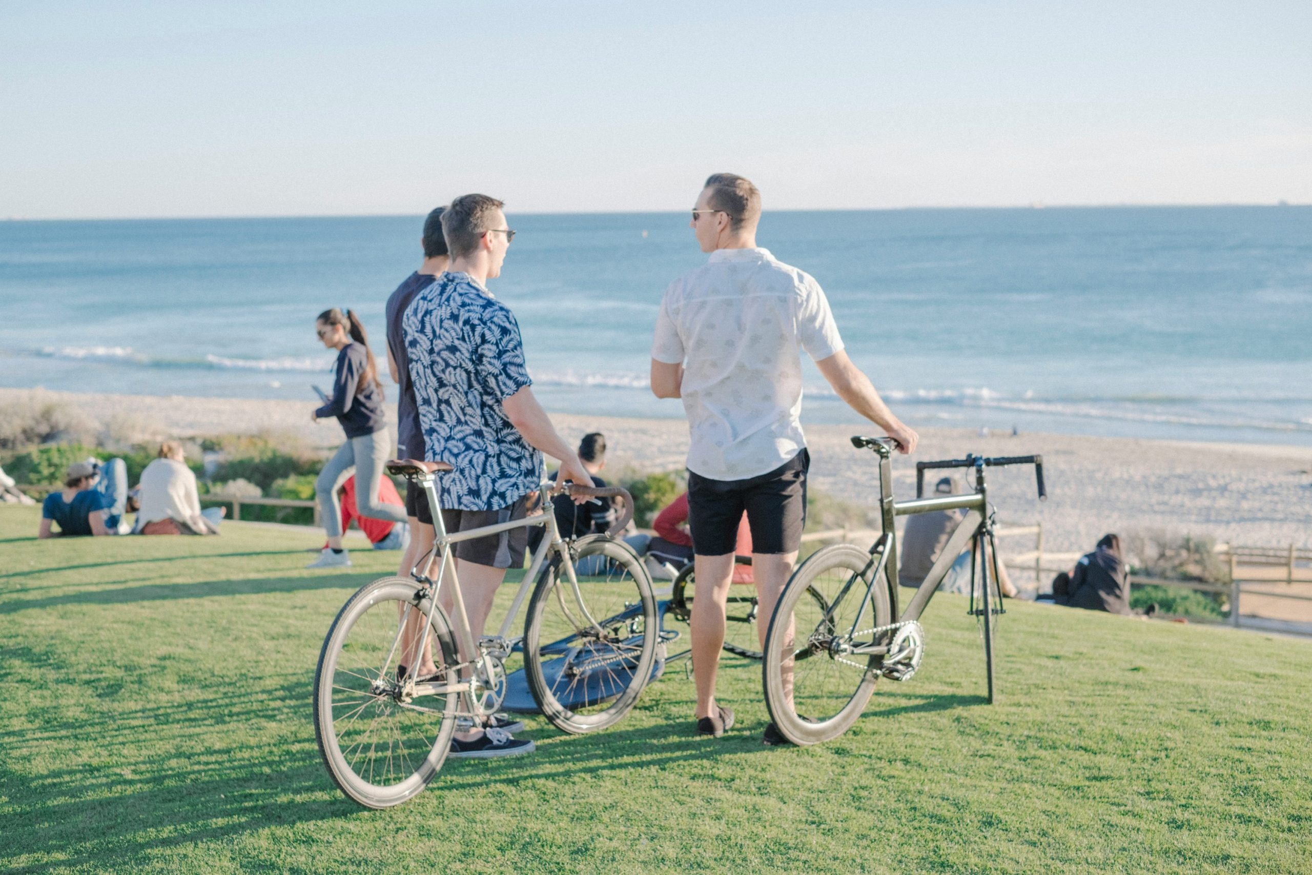 Couple of people resting on their e-bikes near the beach
