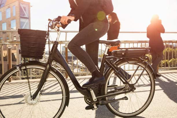 woman getting ready to ride an e-bike