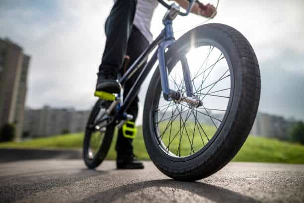 Man`s legs on the bmx bicycle.