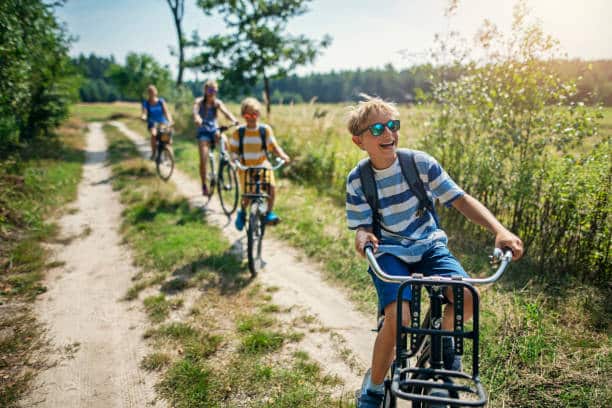 Mother and kids are enjoying a bike trip together. 