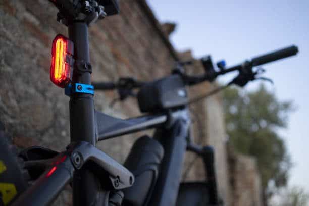 Mountain bike with the rear led light on, black bike frame m4b. Ebike