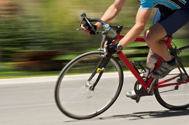 man riding bike on road