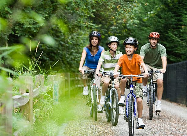 picture of a group of 4 teens riding an e-bike