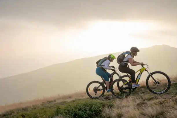 2 bike riderse on hill